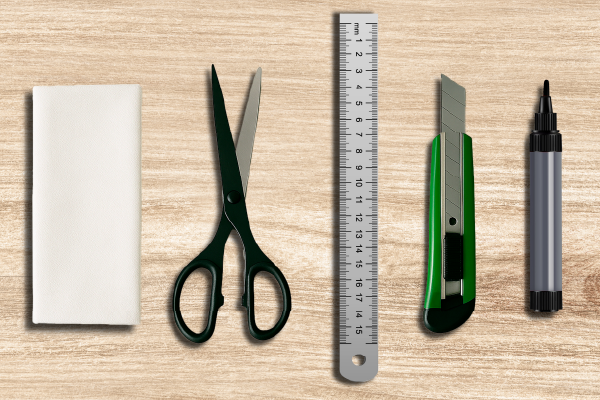 Schul- und Büroset mit Schere, Lineal, Cutter, Marker und Radiergummi Ein Satz mit Büromaterialien bestehend aus Schere, Lineal, Cutter, Marker und Radiergummi auf einem Holzuntergrund
